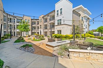 A sunny day at a modern apartment complex with a well-maintained courtyard.