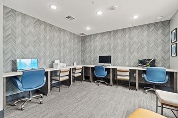 A room with grey patterned wallpaper and a grey carpet.