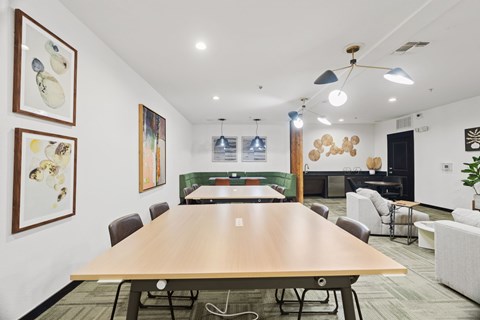 A conference room with a long table and chairs.