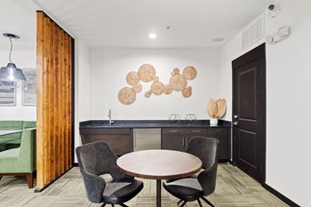 A modern kitchen with a round table and chairs.