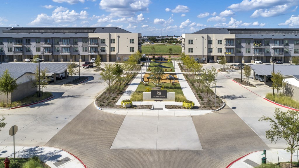 an aerial view of a park in the middle of an apartment complex