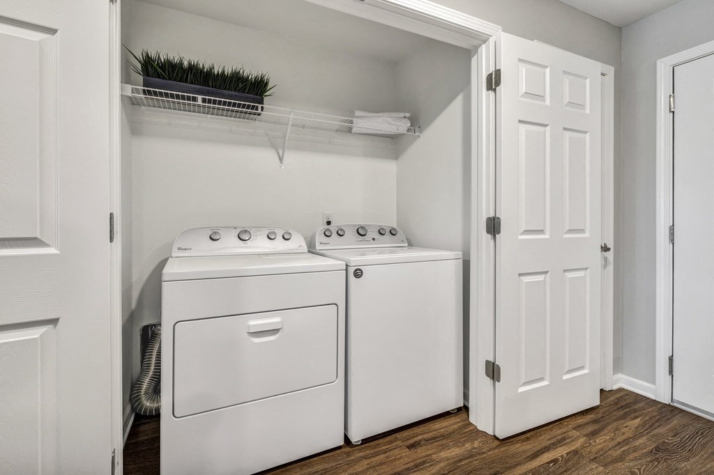 a white washer and dryer in a laundry room with white doors