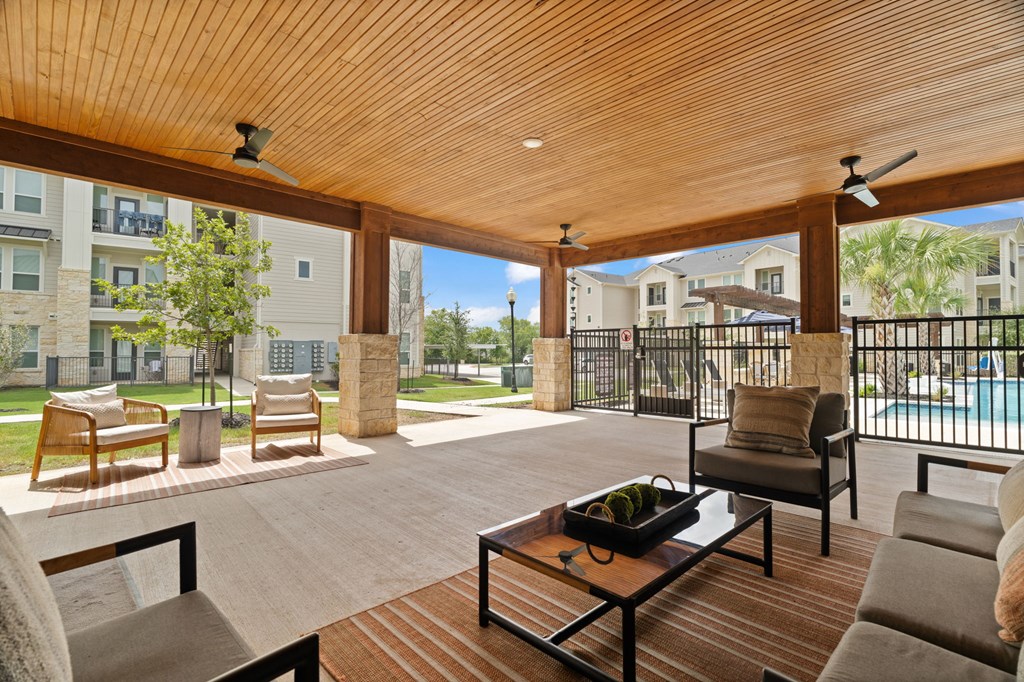 A wooden patio with a table and chairs.