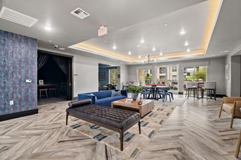 A modern living room with a wooden floor and a variety of furniture.