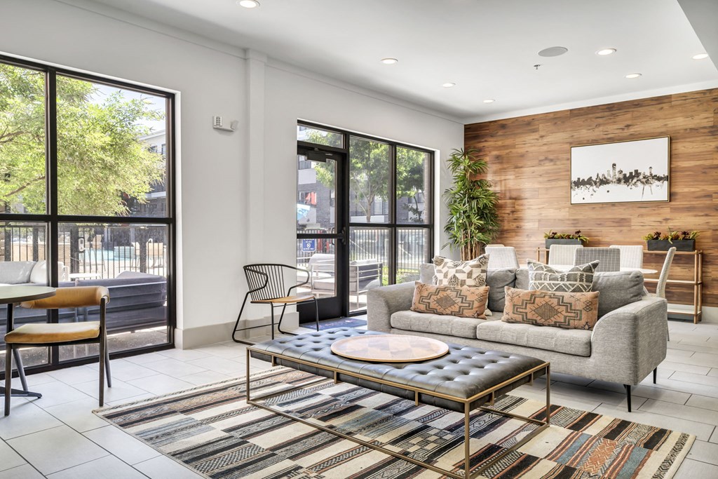 a living room filled with furniture and a large window