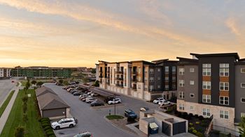 an aerial view of an apartment complex at sunset