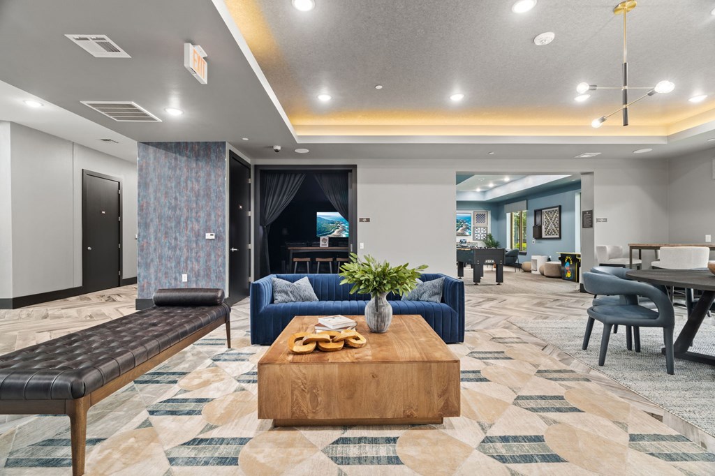A modern living room with a blue sofa and a wooden coffee table.