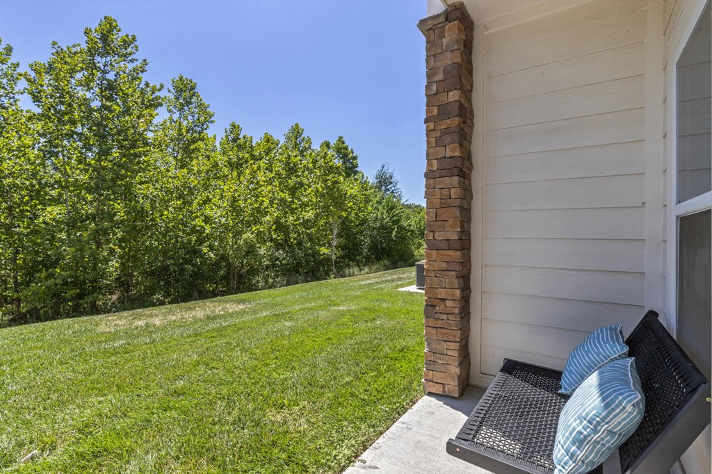 a patio with a couch on the side of a house