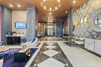 a lobby with blue walls and a marble floor and a chandelier