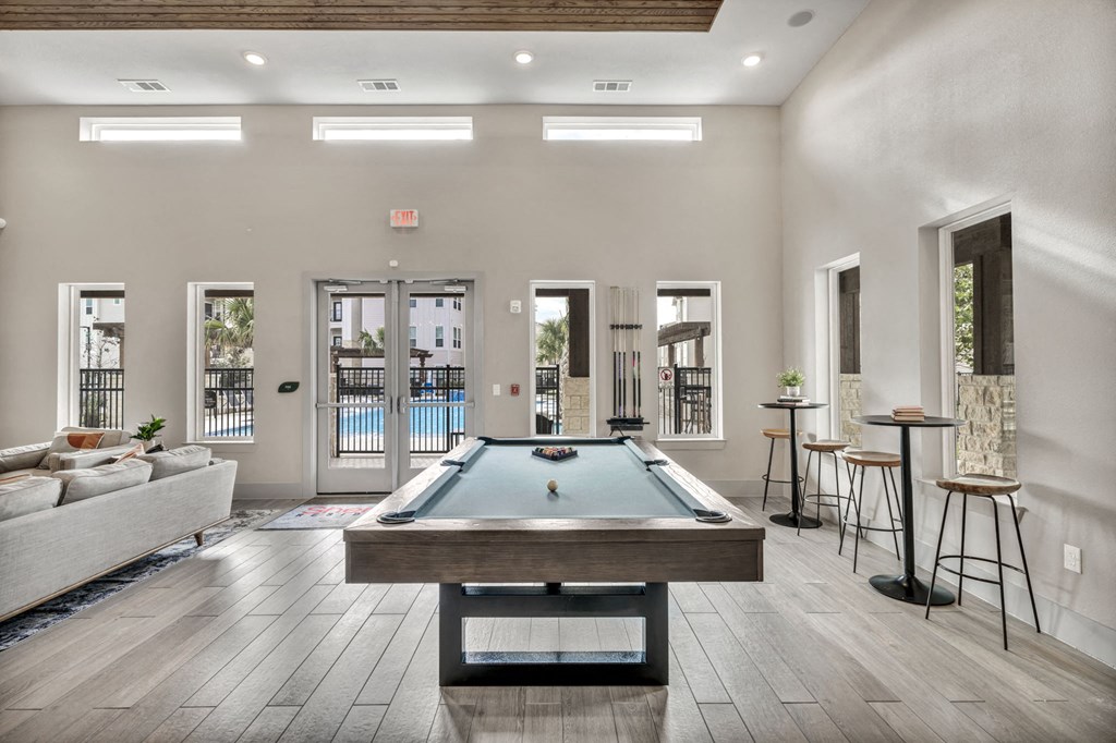 a pool table in the center of a living room