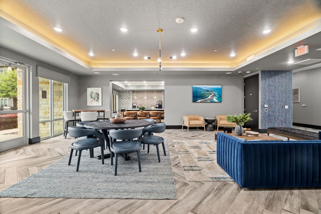 A modern dining room with a large table and chairs.