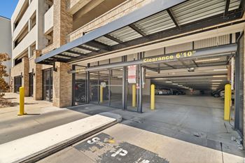 A parking garage entrance with a sign that reads "Clearance 6'10"".