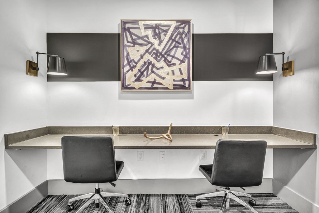 a conference room with two desks and two chairs