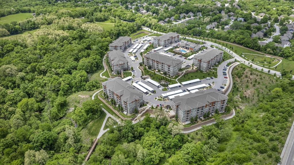 an aerial view of an apartment complex in the woods