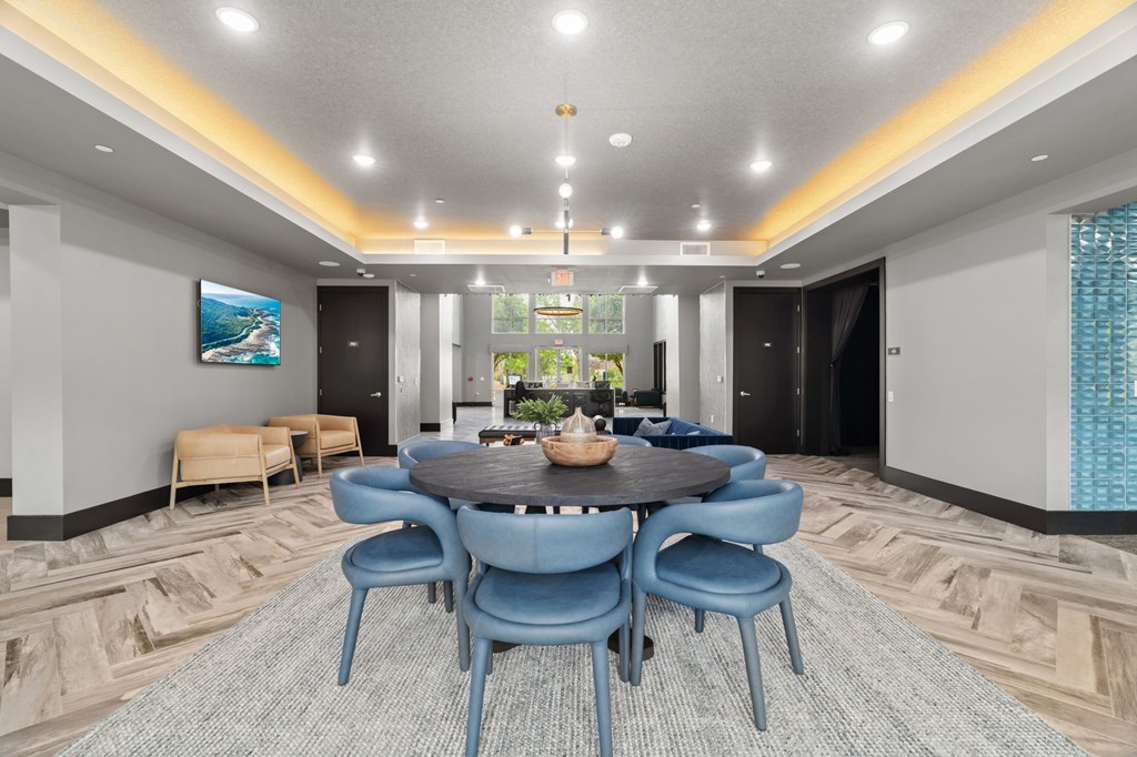A conference room with a large table surrounded by chairs.