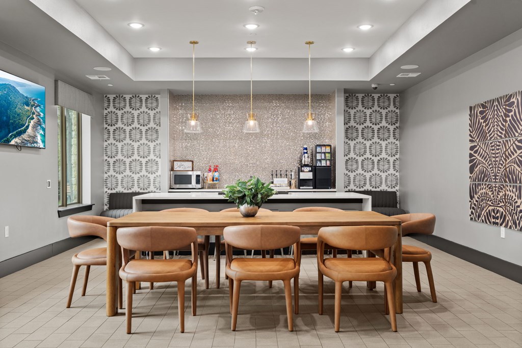 A modern dining room with a wooden table and chairs.