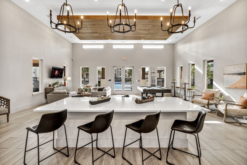 the gathering room has a large center island and bar stools