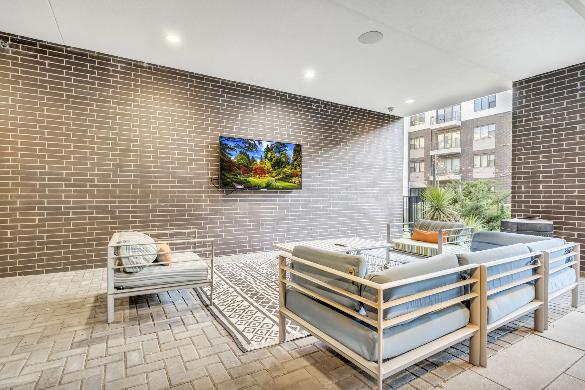 a living room with a brick wall and a couch and a table