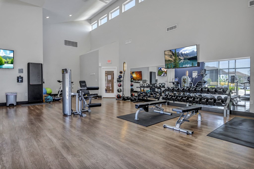 the fitness center at the flats at biggers gym with weights and cardio equipment