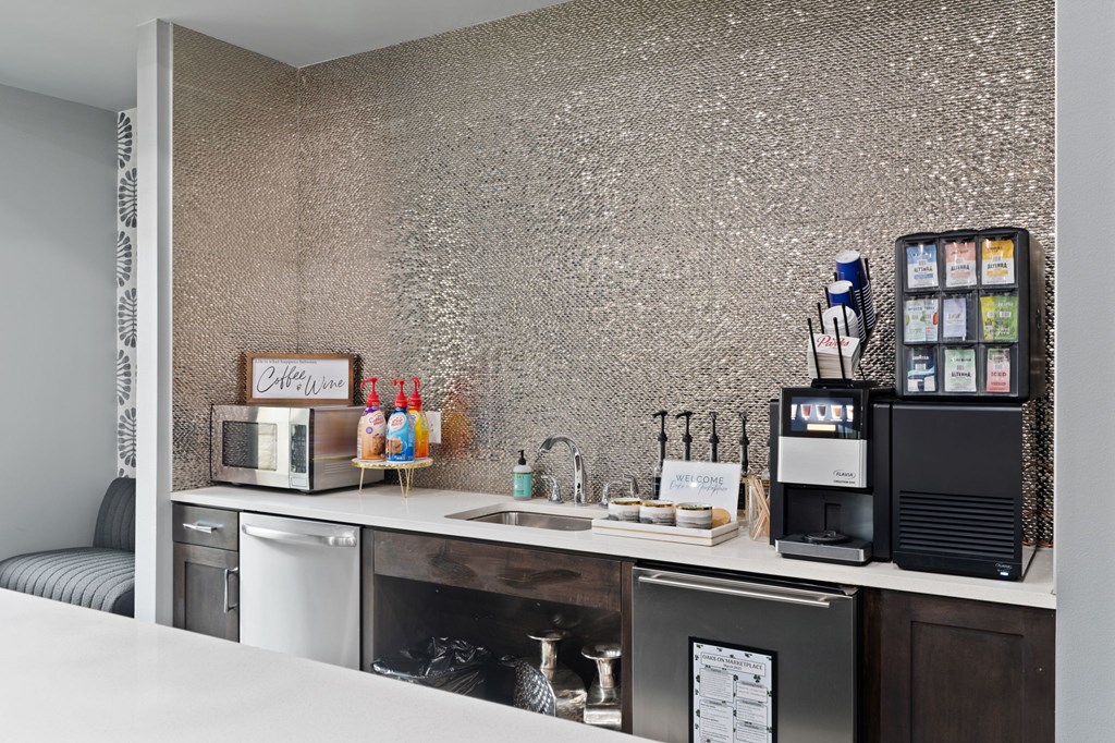 A kitchen with a microwave, dishwasher, and oven.