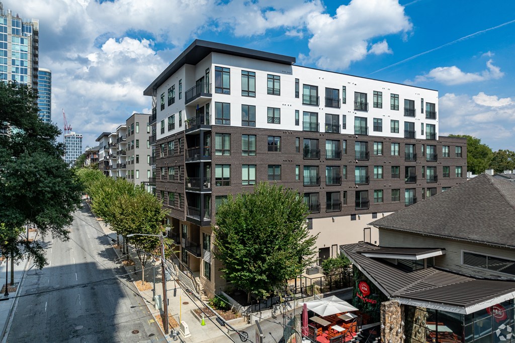 view from the roof of an apartment building with a street in front of it