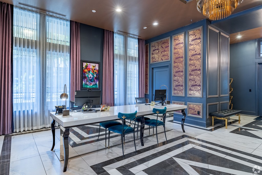 a conference room with two desks and chairs and a chandelier