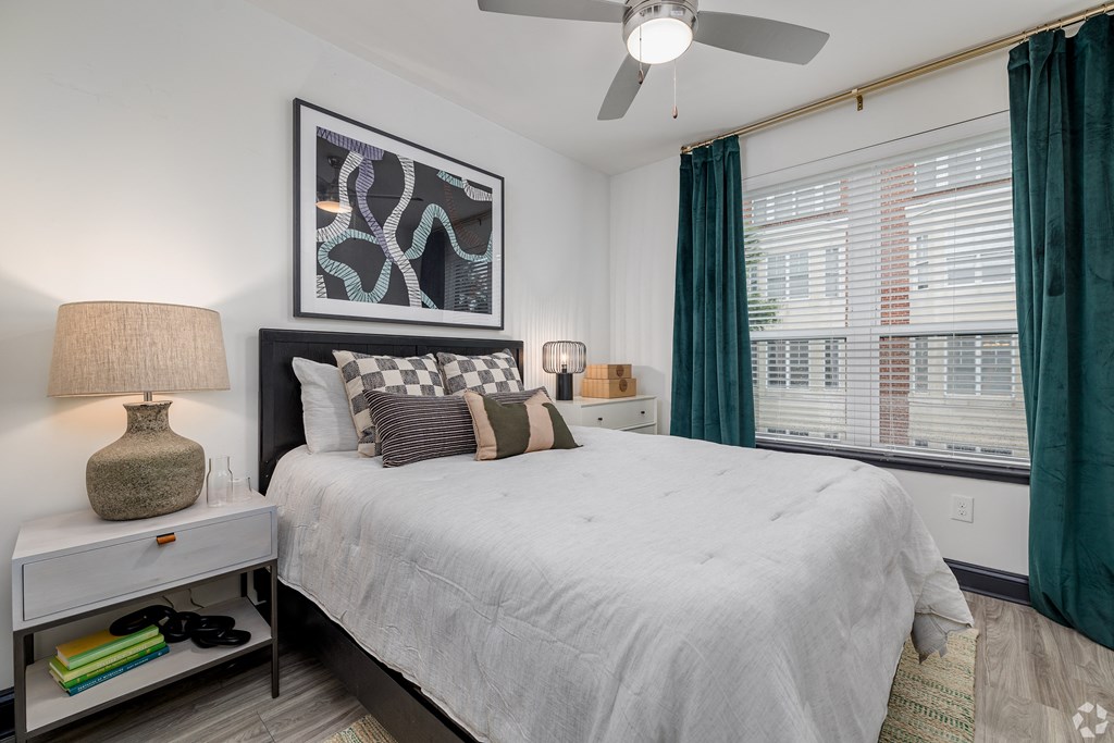 a bedroom with a large bed and a ceiling fan