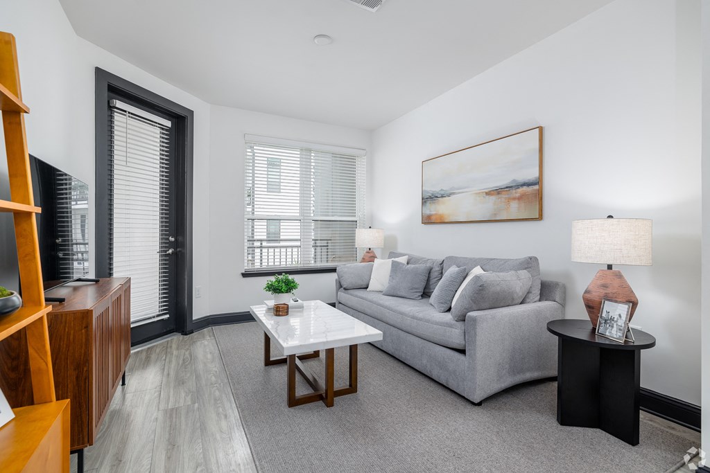 a living room with a couch and a coffee table and a tv