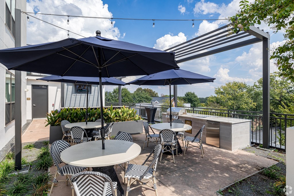 a patio with tables and umbrellas on a roof