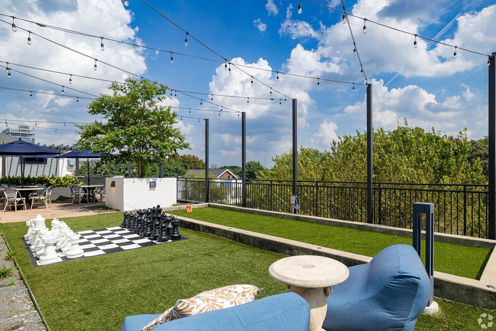 a backyard with a chess board and a lawn