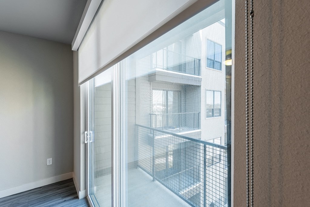 a view of a balcony from a room with glass doors