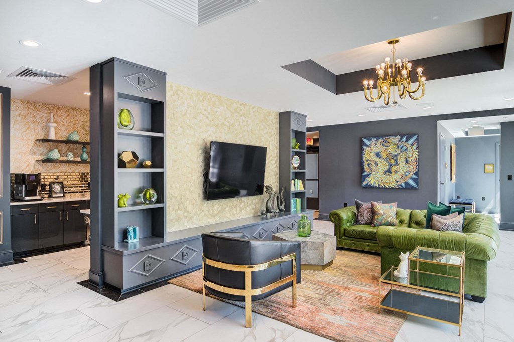 a living room with a green couch and a television