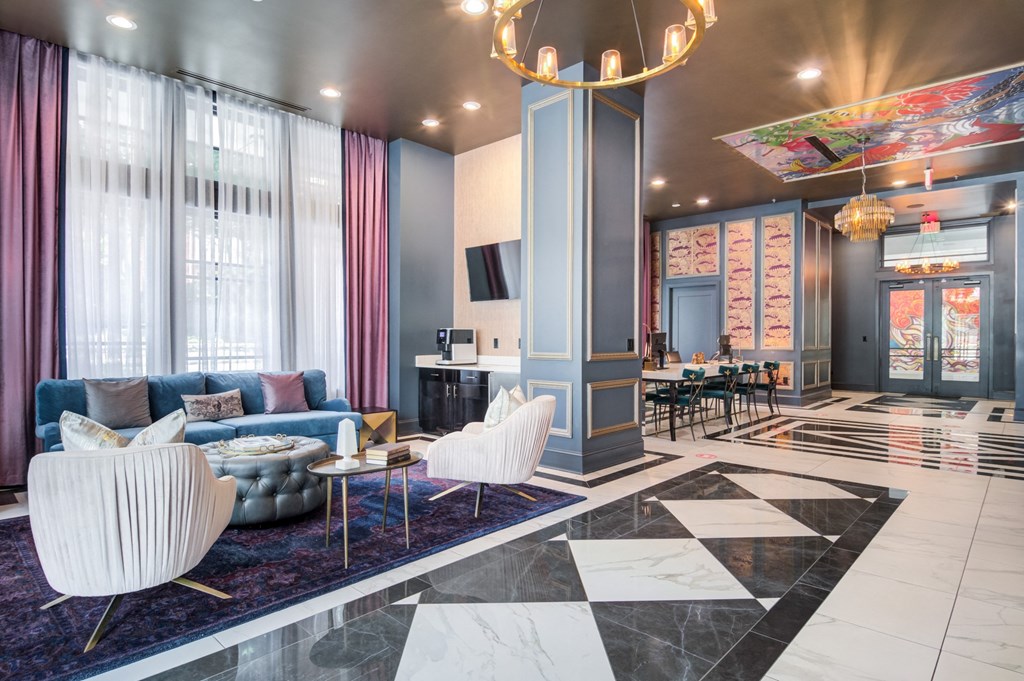 a lobby with blue and white furniture and a large chandelier