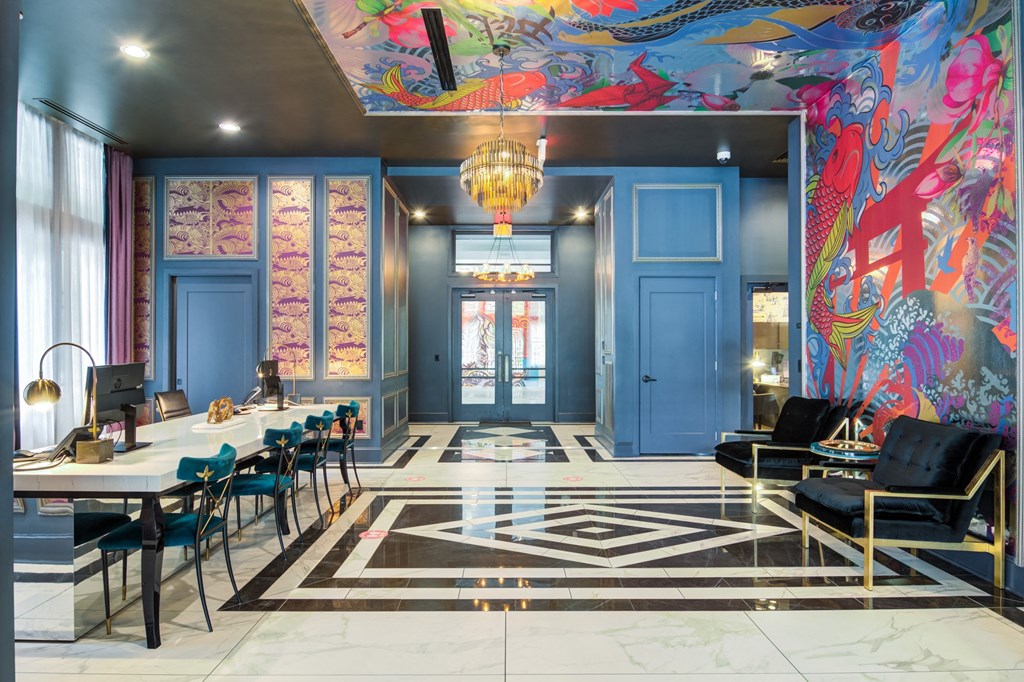 a lobby with blue doors and chairs and a checkered floor