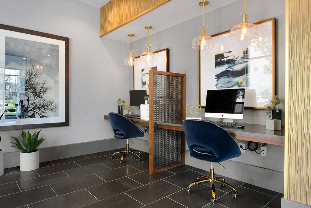 an office with a desk and chairs and a computer