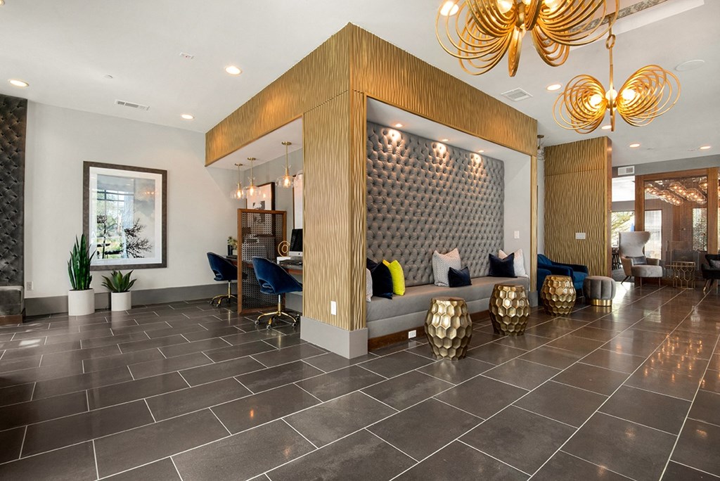 the lobby of a hotel with a couch and chairs