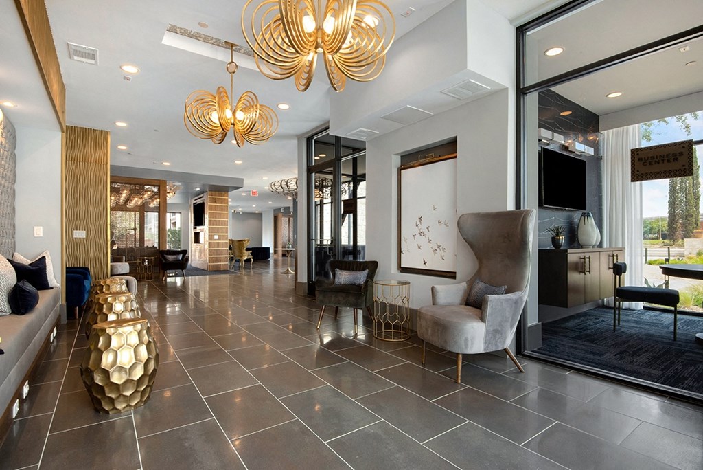the lobby of a hotel with a reception desk and chairs