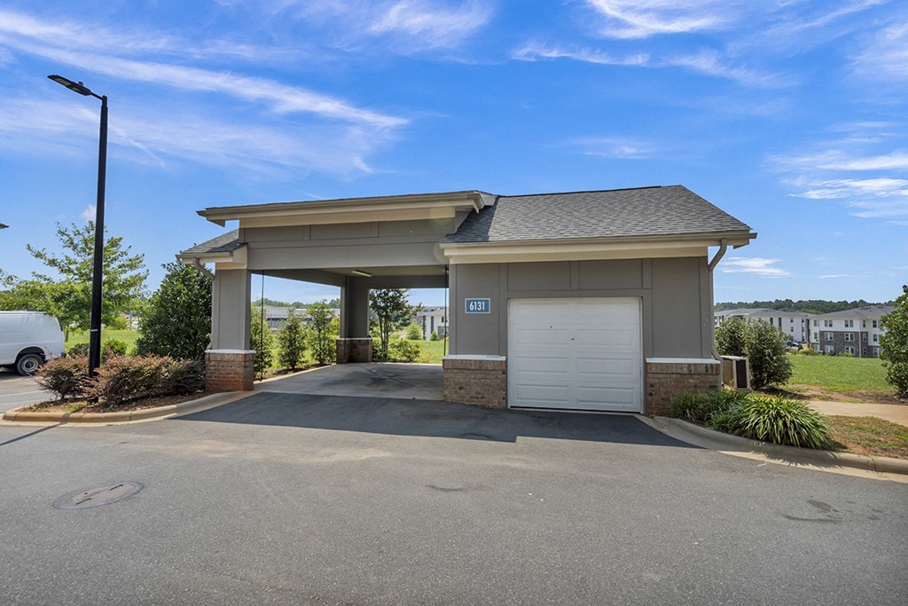 a garage with a white door in front of a driveway