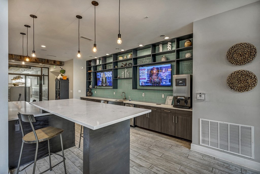 a kitchen with a white counter top and a tv