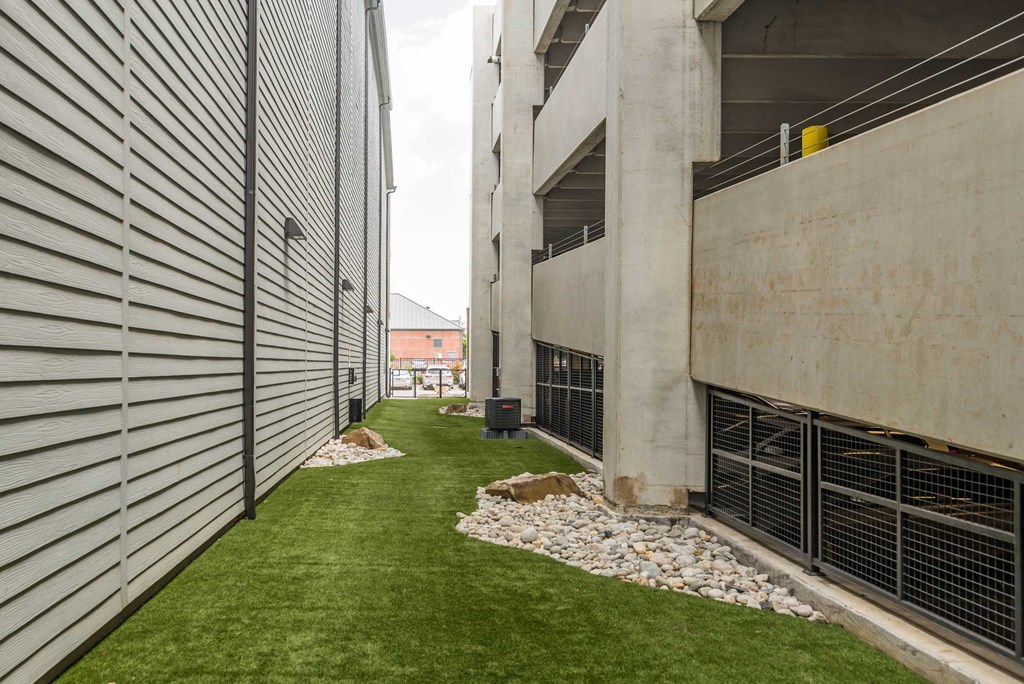 a grassy area between two buildings