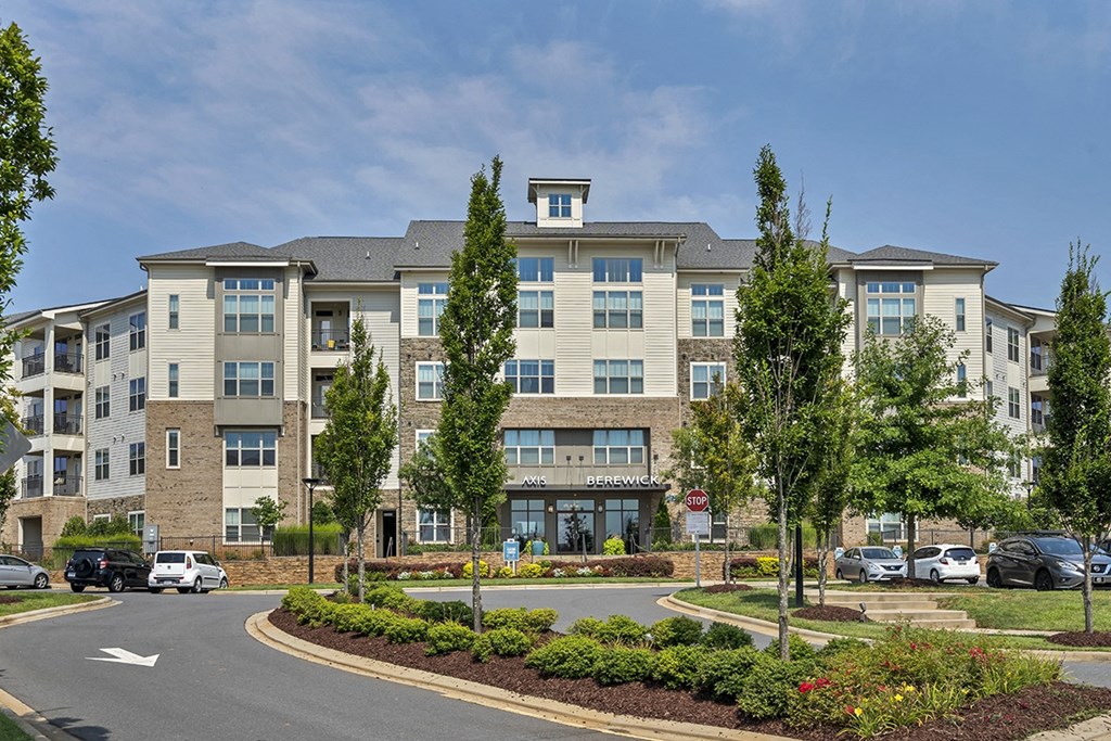 an apartment building with cars parked in front of it