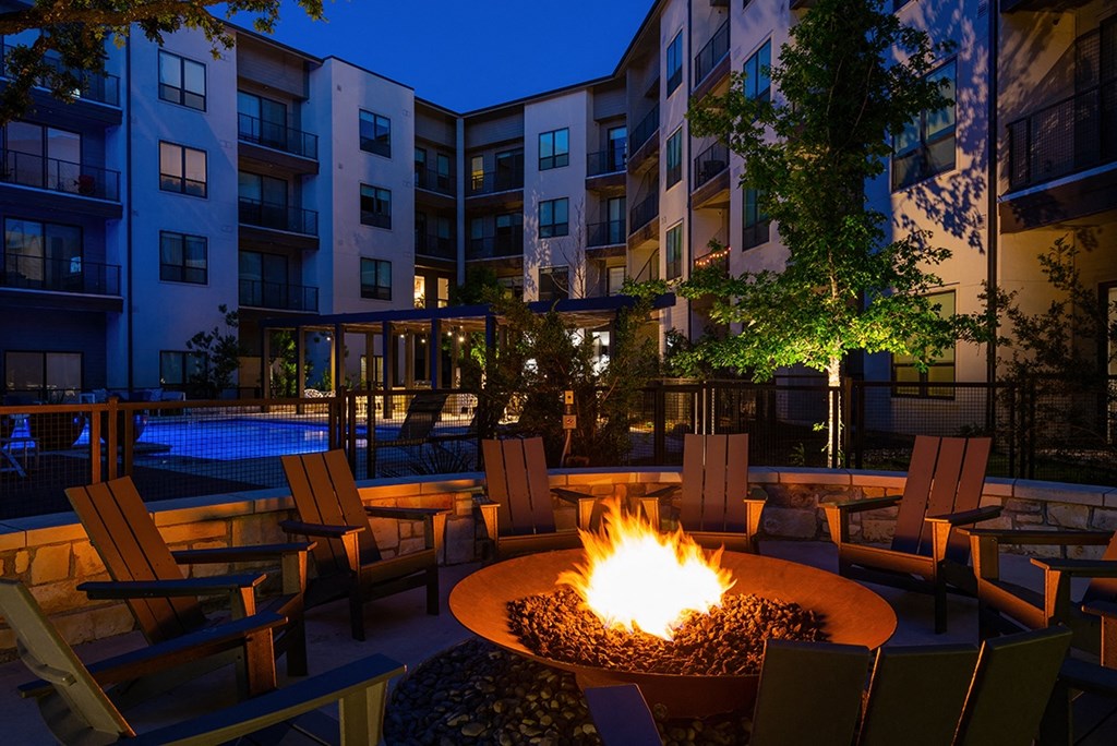 a fire pit at night at an apartment complex