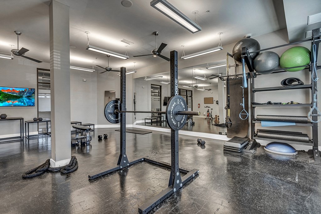 a gym with weights and other equipment in a building