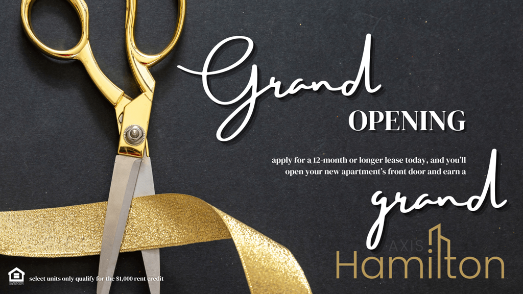 a pair of scissors and a gold ribbon on a black table