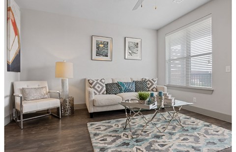 a living room with a couch and a glass table