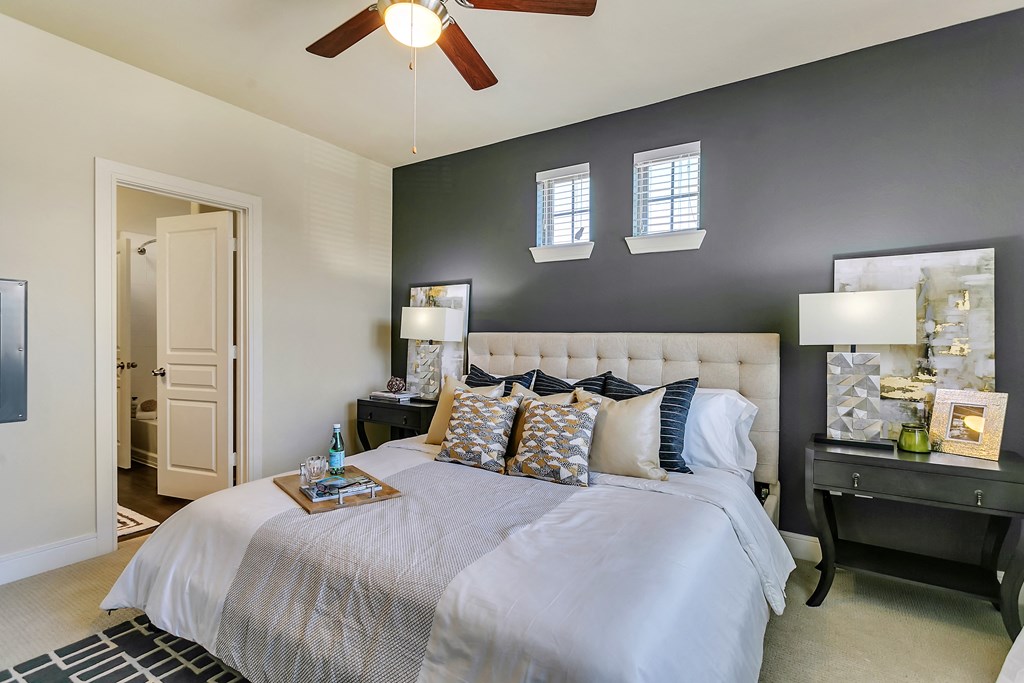 a bedroom with a large bed and a ceiling fan