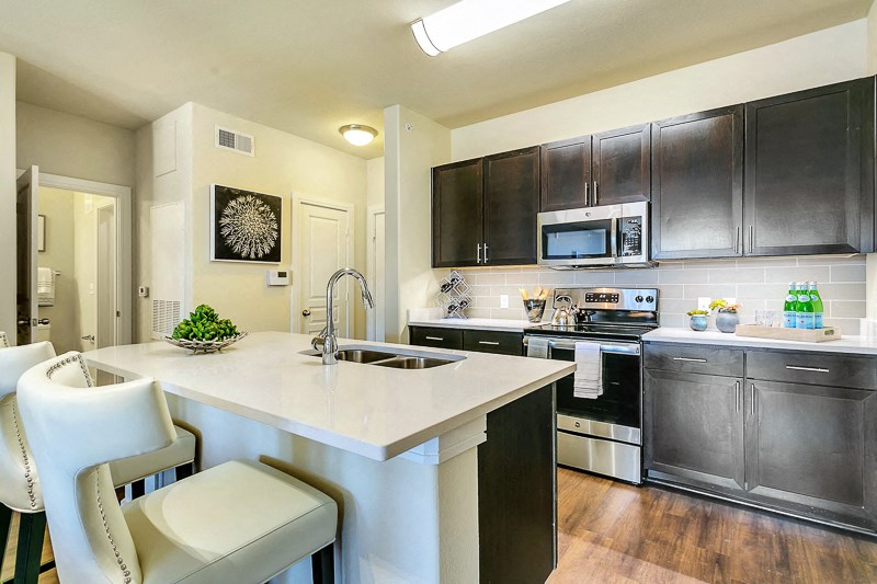 a kitchen with stainless steel appliances and a marble counter top