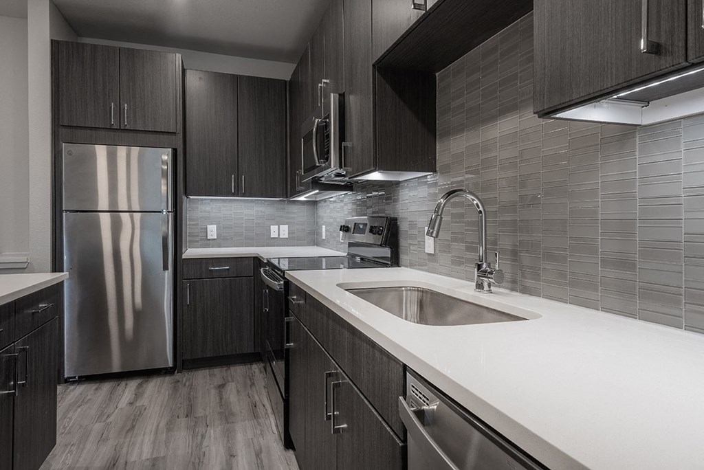 a kitchen with a sink and a refrigerator