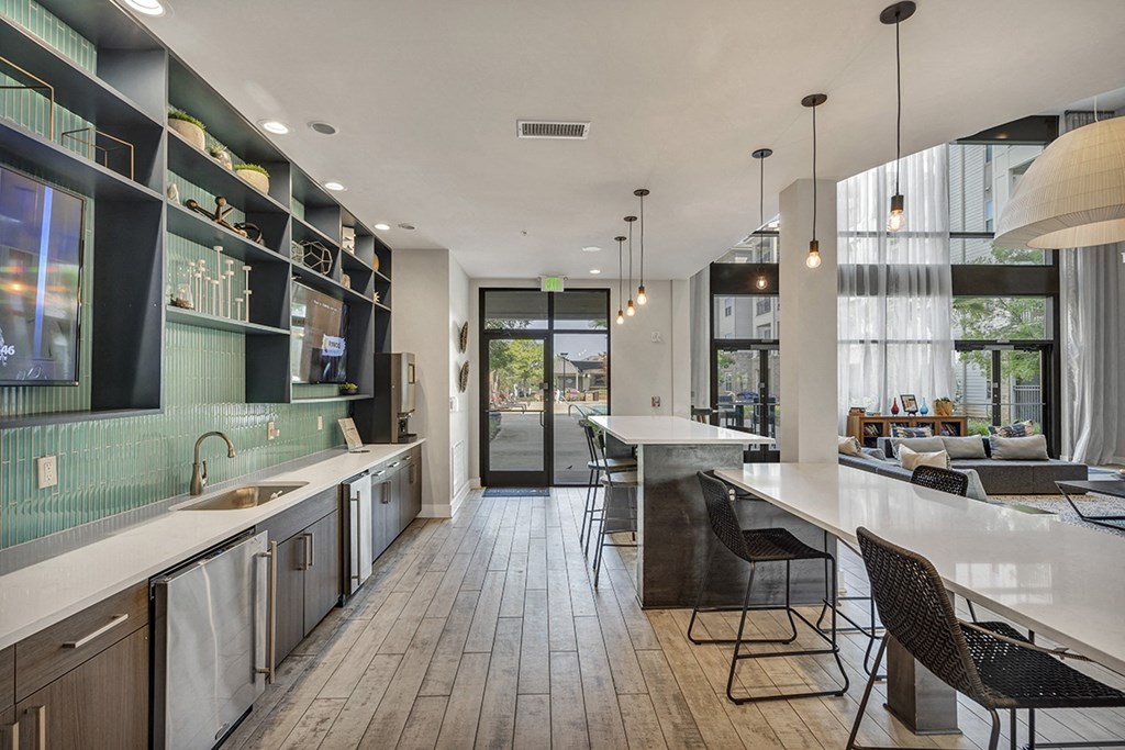 a kitchen and living room with a table and chairs