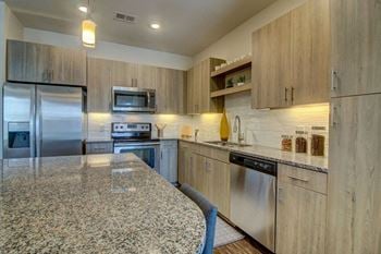 Fully Equipped Kitchen Includes Frost-Free Refrigerator, Electric Range, & Dishwasher at Altitude 970, Kansas City
